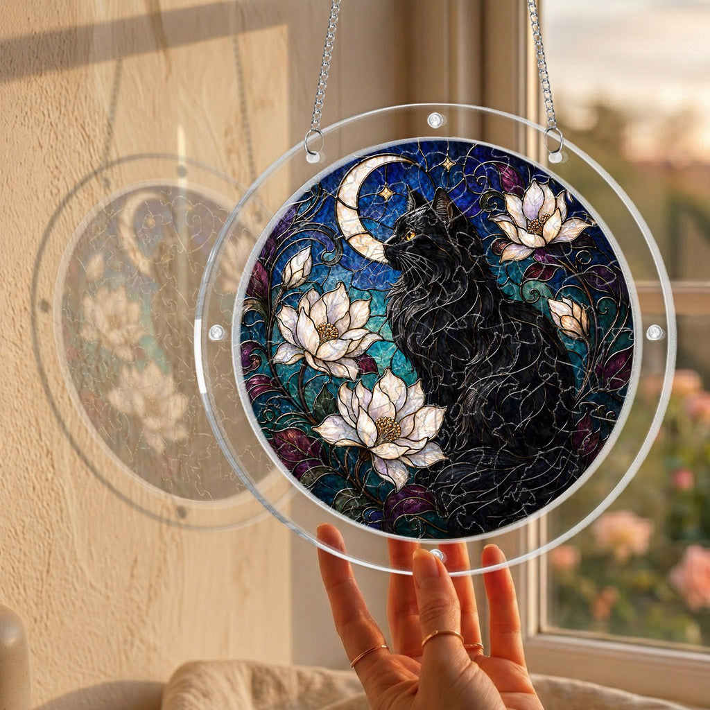Black cat memorial puzzle suncatcher held up to a sunlit window