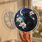 Black cat memorial puzzle suncatcher held up to a sunlit window