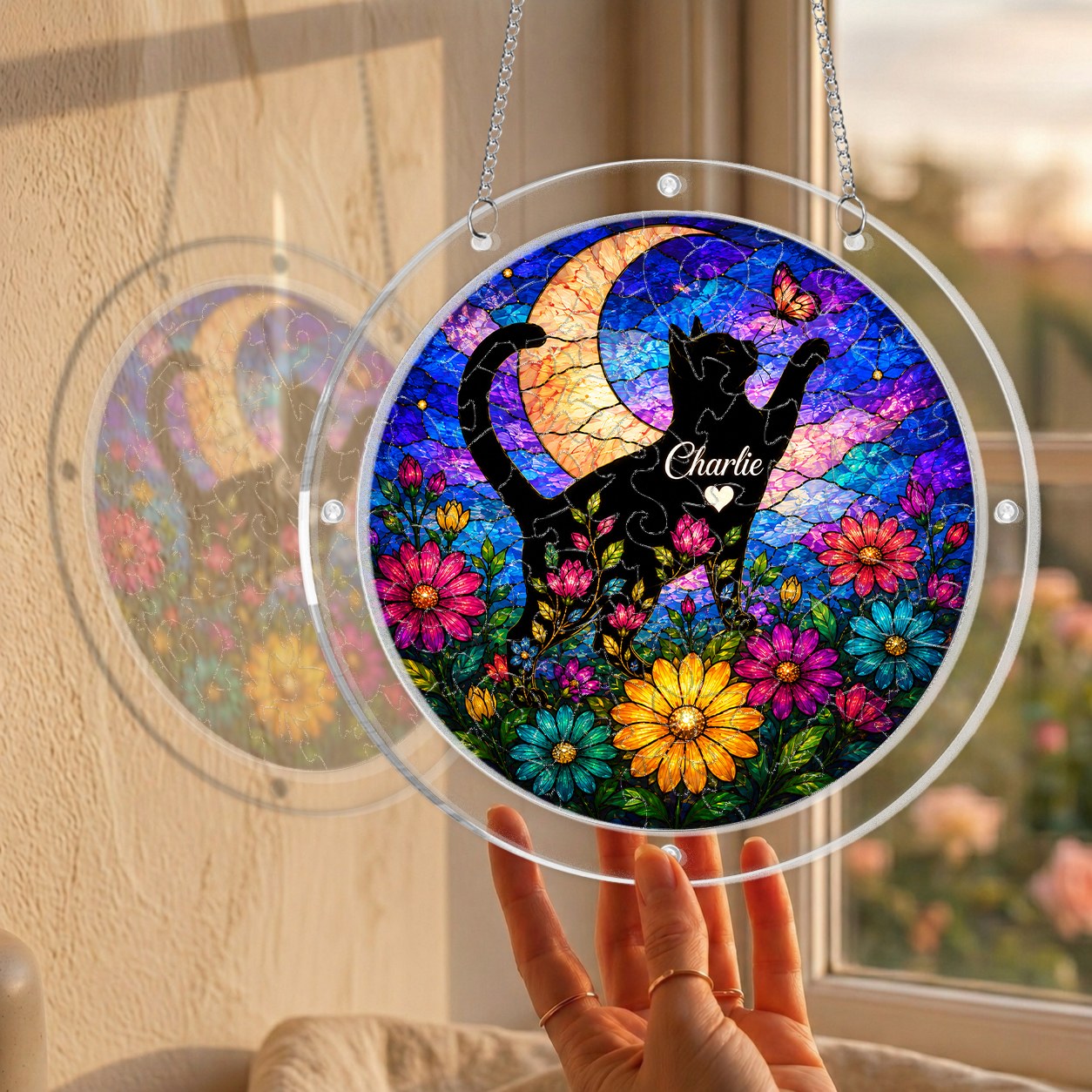 Cat memorial puzzle suncatcher held up to a sunlit window