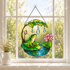 Frog suncatcher hanging in a bright kitchen window