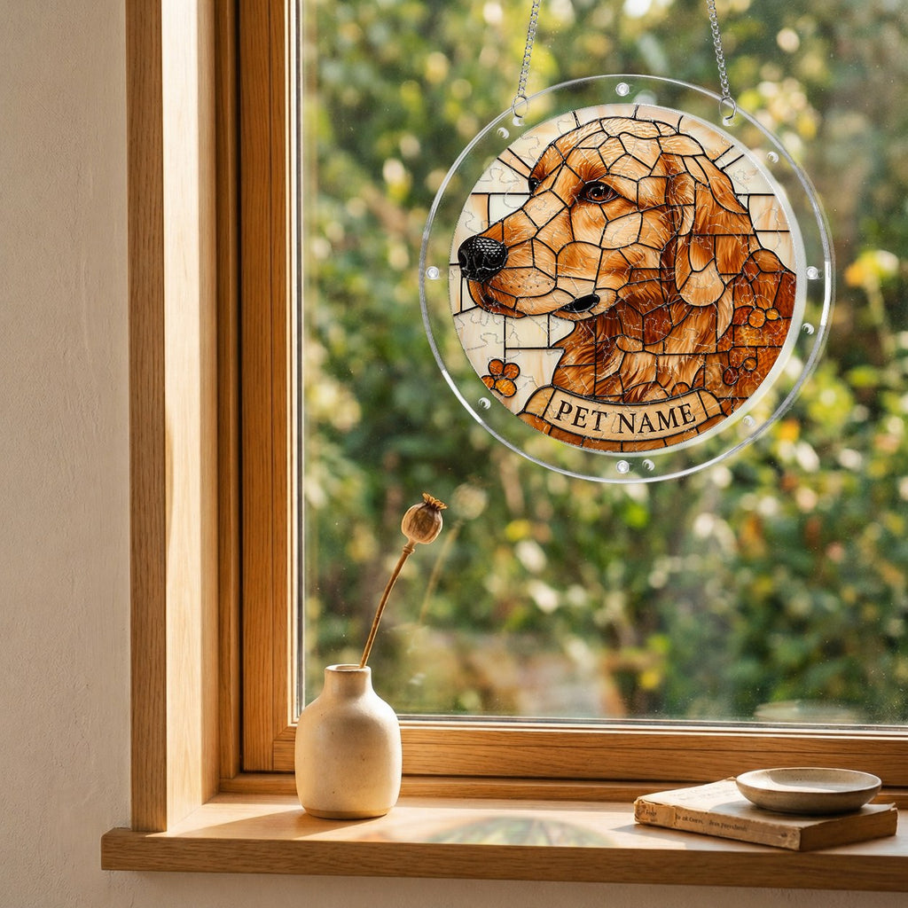 Golden mosaic dog suncatcher hanging in a wooden window with a garden view