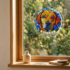 Rainbow mosaic dog suncatcher hanging in a wooden window with a garden view