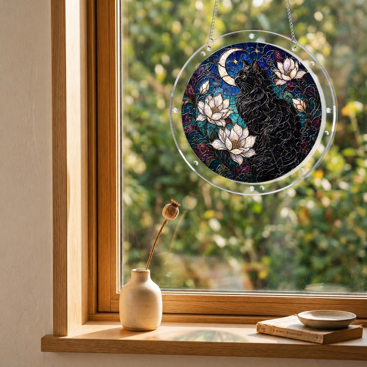 Black cat memorial puzzle suncatcher hanging in a sunny window