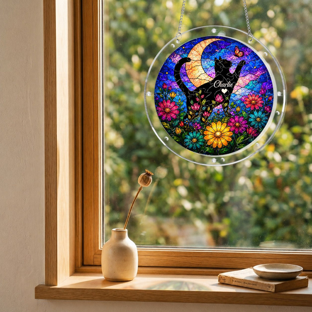 Cat memorial puzzle suncatcher hanging in a sunny window