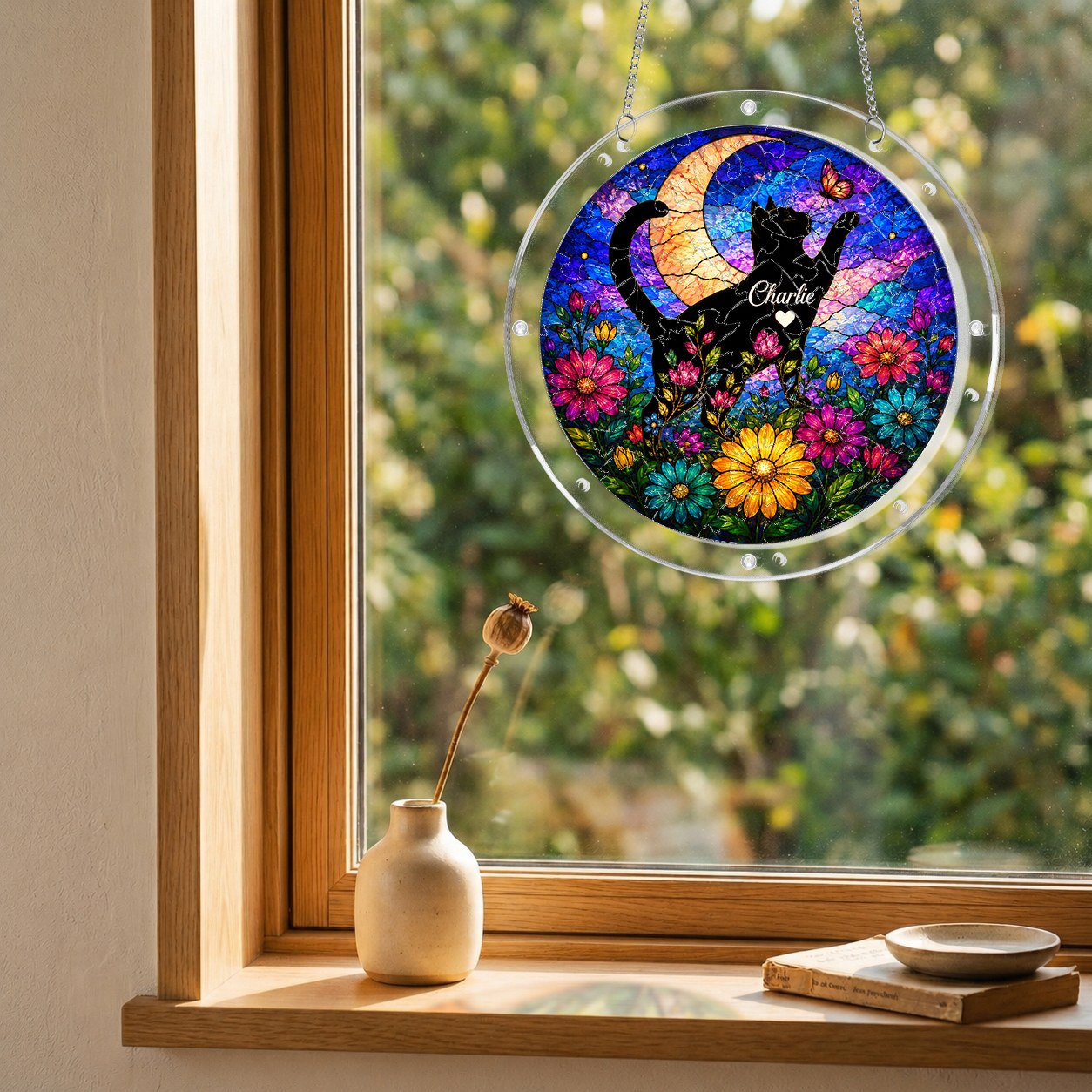 Cat memorial puzzle suncatcher hanging in a sunny window