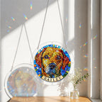 Rainbow mosaic dog memorial suncatcher hanging in a sunlit window with sheer curtains