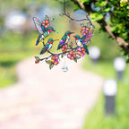 Decorative hologram acrylic suncatcher panel with colorful hummingbirds and flowers, hanging outdoors.