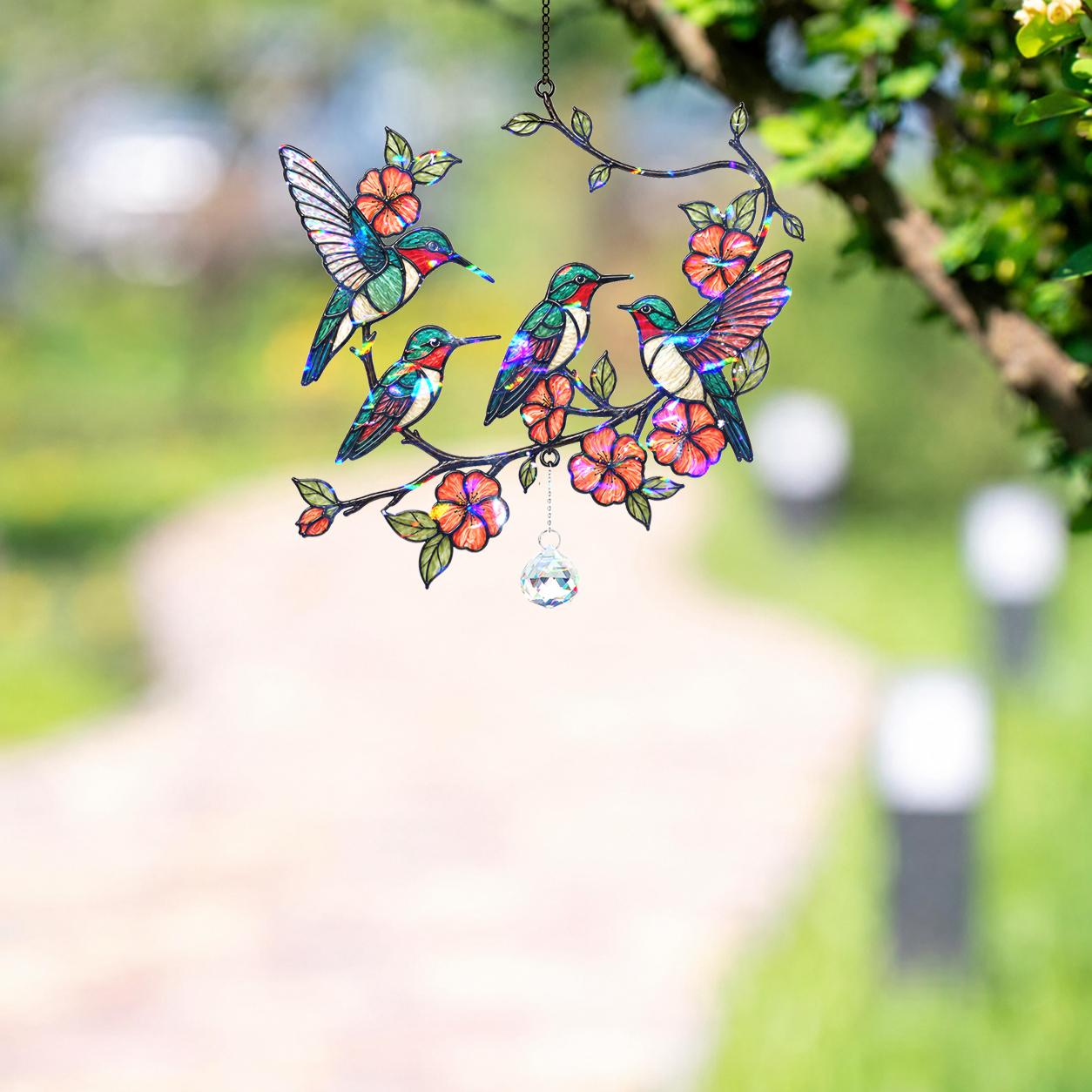 Decorative hologram acrylic suncatcher panel with colorful hummingbirds and flowers, hanging outdoors.