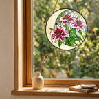 Pink lily suncatcher in a cozy window with a small vase and soft natural light