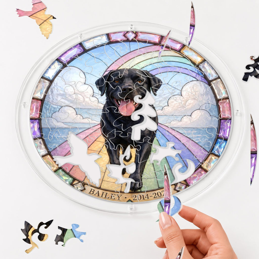 Hands assembling the black Labrador memorial puzzle suncatcher puzzle pieces