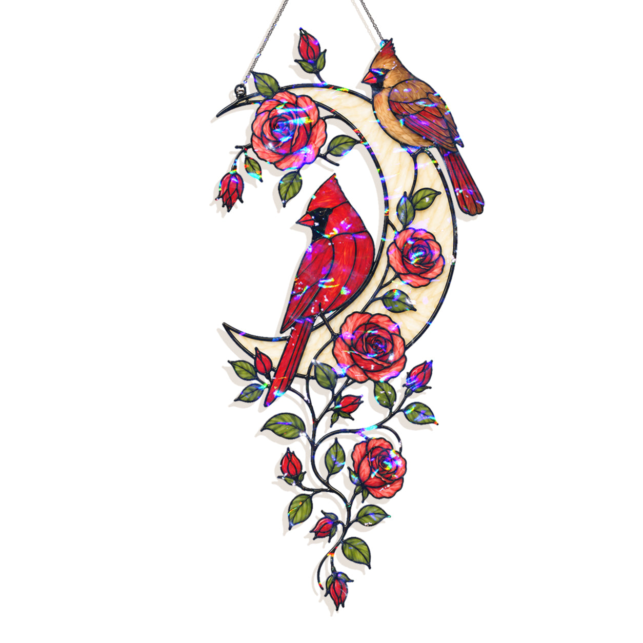 A stained glass hanging ornament featuring two cardinals perched on a crescent moon with roses and leaves, suspended by a string against a plain white background.