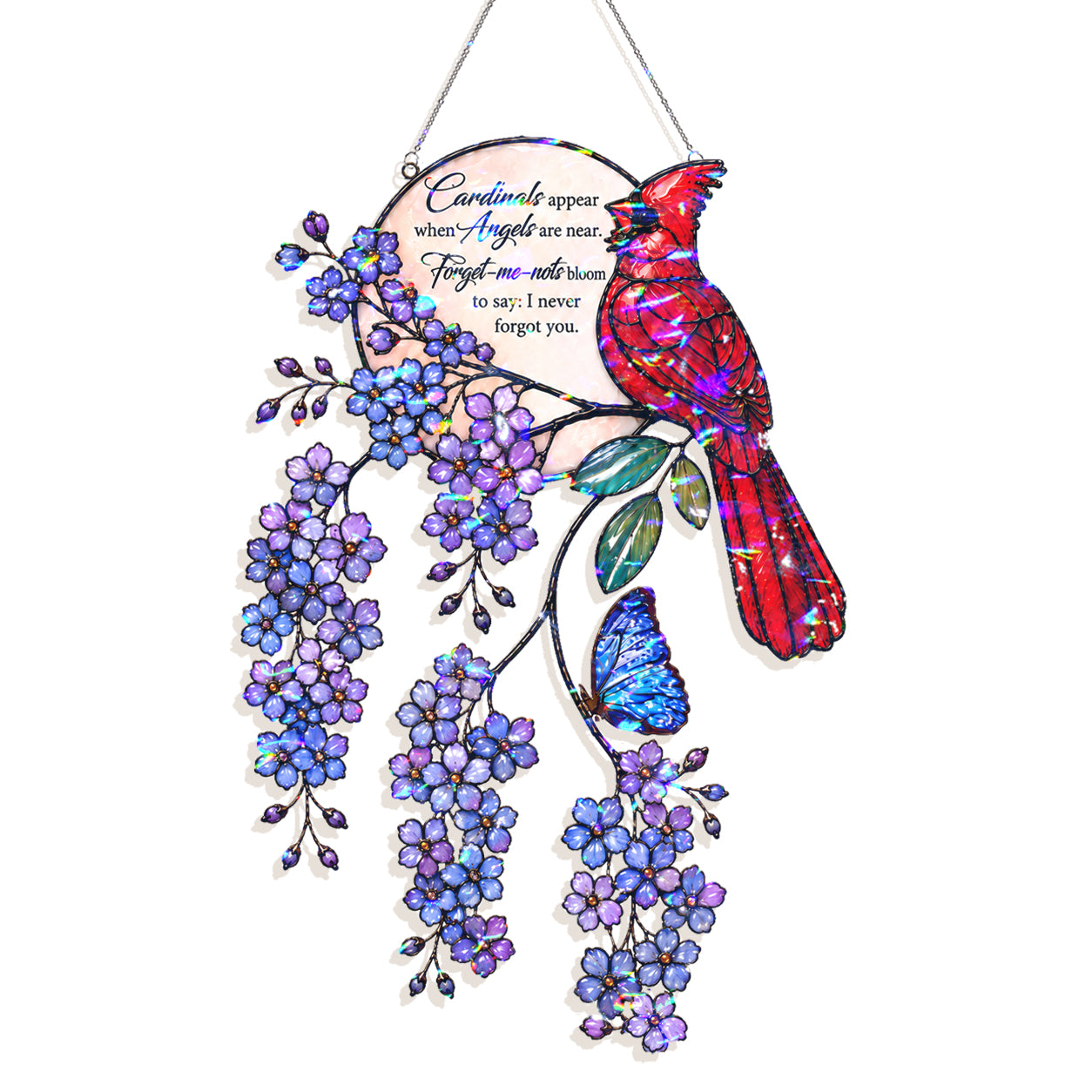 A decorative hanging ornament featuring a colorful cardinal bird perched on a flowering branch with purple blossoms and a blue butterfly. The ornament includes a circular inset with memorial-style text and is shown against a plain white background.