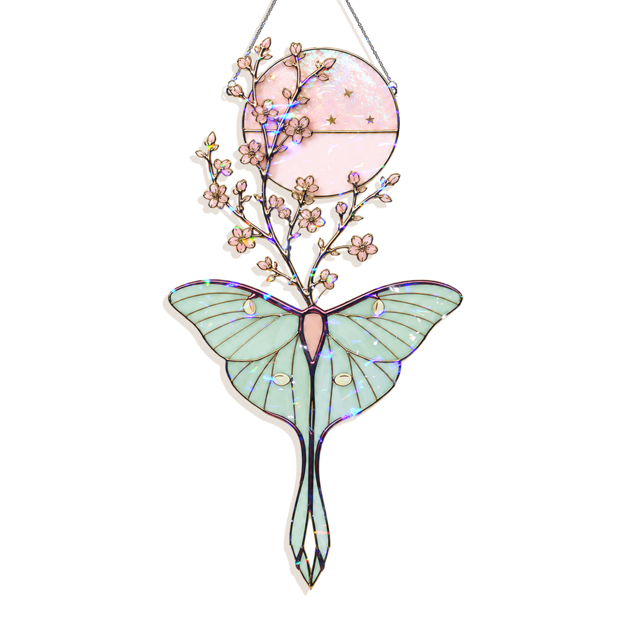 A hanging stained-glass style ornament shaped like a large pale green moth with a pink circular sun and small pink flowers above it, outlined in dark metal and shown on a white background.