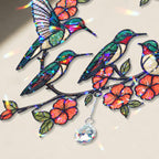 Decorative hologram arcylic suncatcher with colorful hummingbirds and flowers on a light background