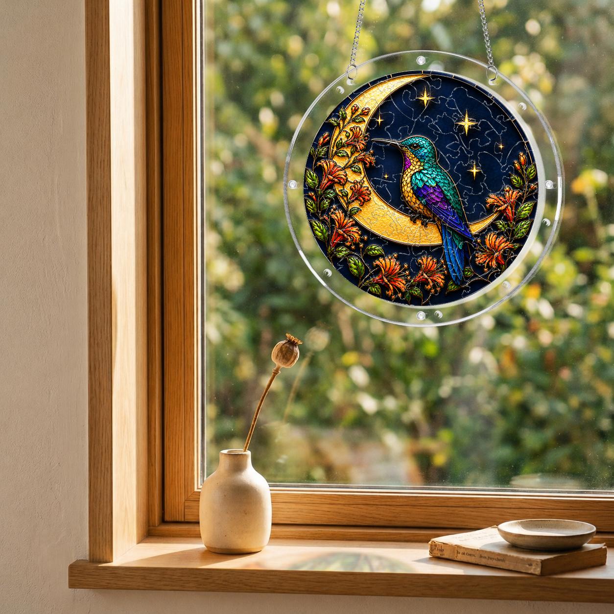 Hummingbird crescent-moon puzzle suncatcher mounted on a clear round acrylic frame