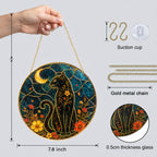 Black cat crescent moon stained glass suncatcher hanging in a sunlit window