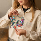 Person holding a colorful hologram arcylic hummingbird and flower suncatcher 