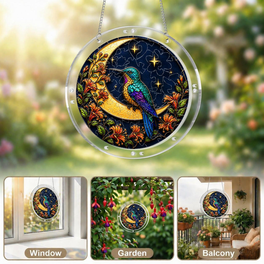Hummingbird crescent-moon puzzle suncatcher on its hanging chain against a white background