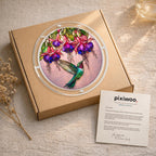 Hummingbird fuchsia puzzle suncatcher hanging by a sunlit garden window