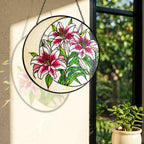 Stargazer lily suncatcher near a window with colorful light reflection on the wall