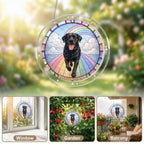 Black Labrador memorial puzzle suncatcher hanging by a sunlit garden window