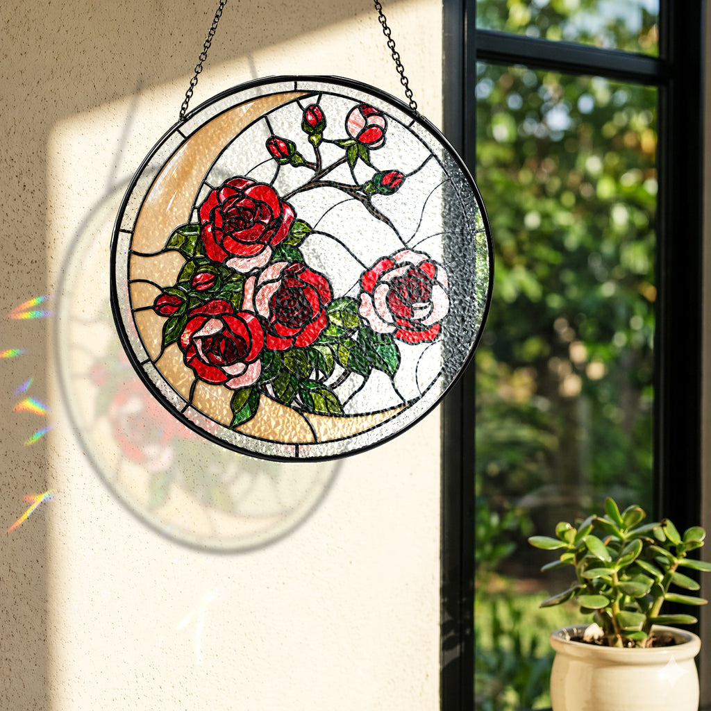 Rose stained glass suncatcher near a window with colorful light reflection on the wall
