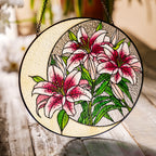 Pink lily stained glass suncatcher in a bright window with soft daylight
