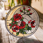 Red rose stained glass suncatcher in a bright window with soft daylight