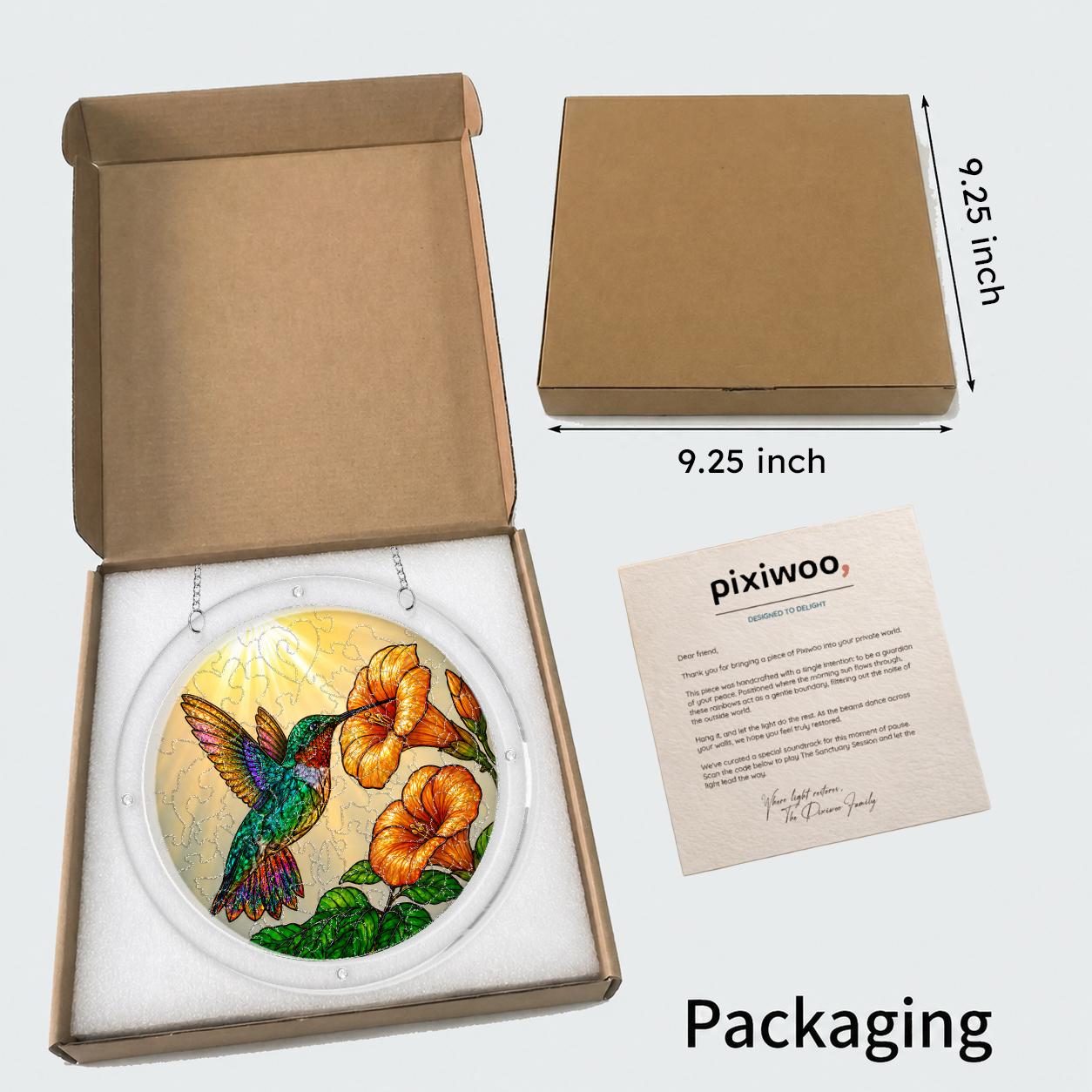 Open kraft gift box with the hummingbird trumpet-flower puzzle suncatcher and insert card