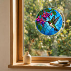 Round hummingbird and fuchsia puzzle suncatcher hanging in a cozy indoor window with soft daylight