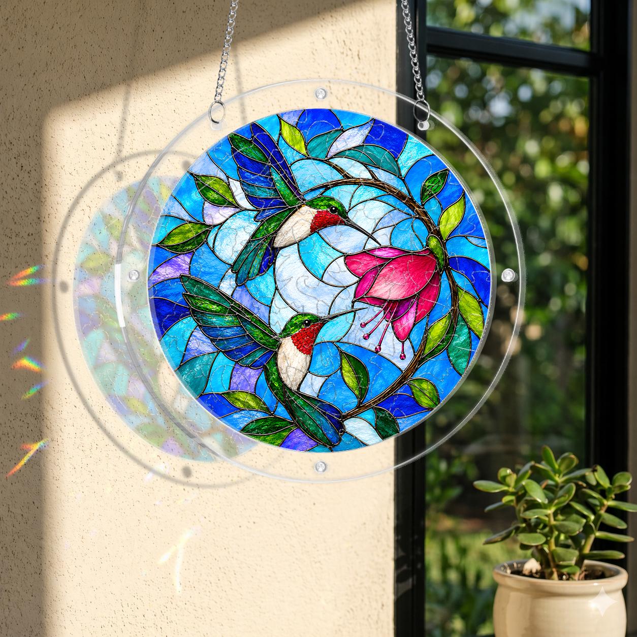Round stained-glass-style hummingbird and pink flower puzzle suncatcher hanging in natural window light