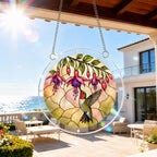 Hummingbird fuchsia acrylic puzzle suncatcher hanging on an outdoor patio window with a sunny balcony view