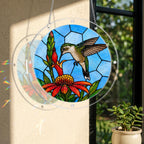 Round stained-glass-style hummingbird floral puzzle suncatcher hanging in natural window light
