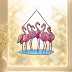 Flamingo flock holographic acrylic suncatcher reflecting rainbow light across a room