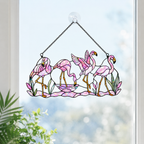 Tropical flamingo holographic suncatcher catching sunlight and casting rainbow reflections in a window
