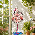 Standing pink flamingo holographic suncatcher catching sunlight and casting rainbow reflections in a window