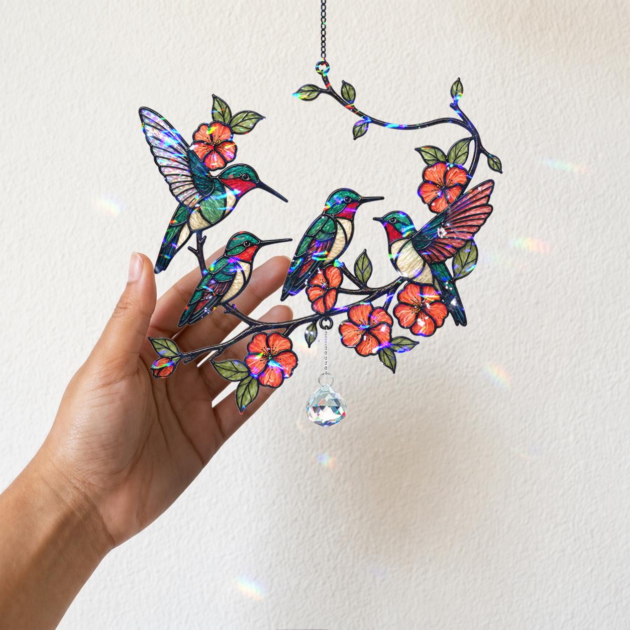Detailed close-up of multiple hummingbirds, blossoms, and leafy branch artwork on holographic acrylic.
