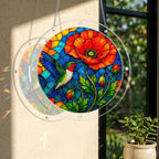 Round stained glass style hummingbird poppy suncatcher hanging on a window with warm natural sunlight