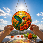 Hummingbird and orange flower puzzle suncatcher held outdoors against a bright blue sky and garden background