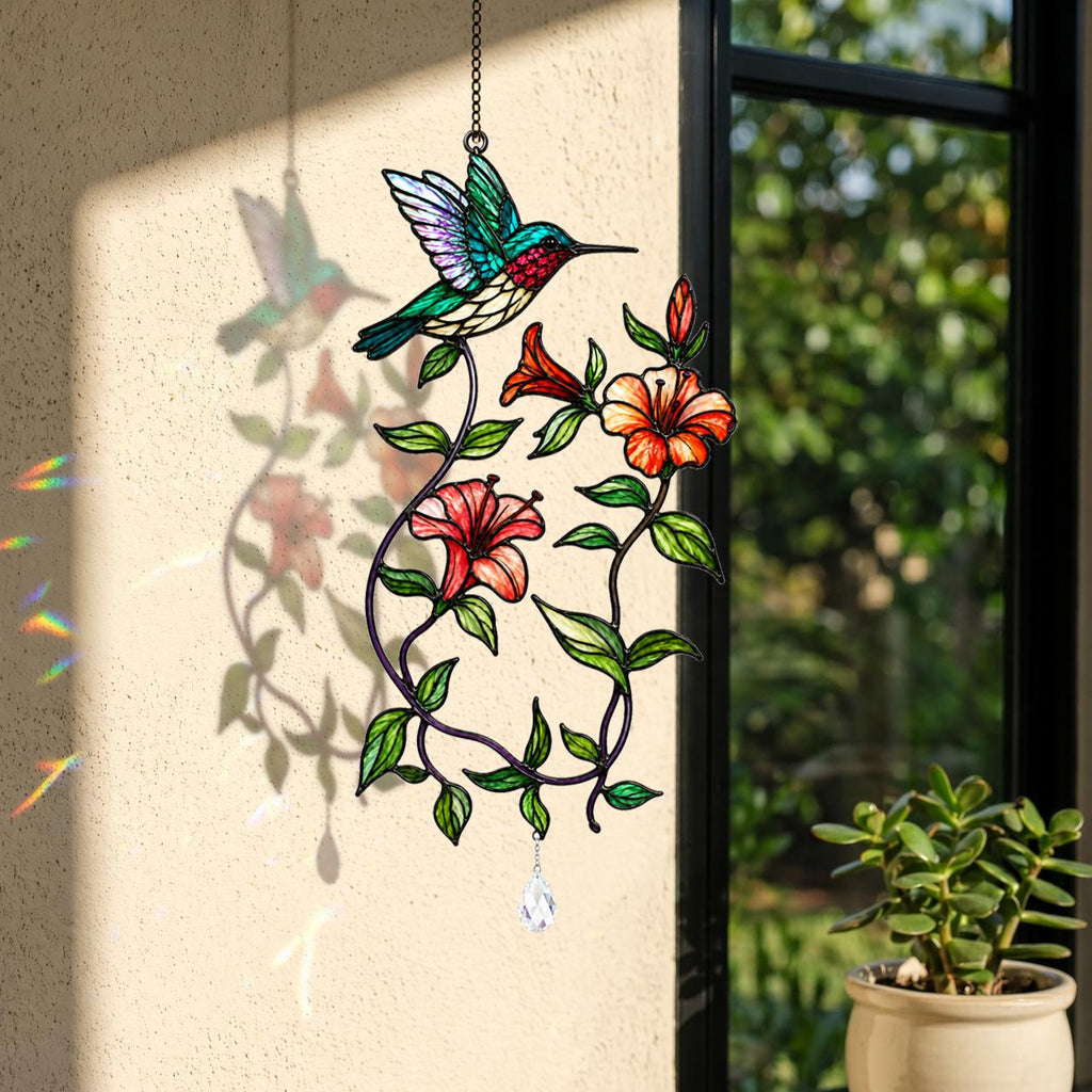 Hummingbird blooming vine holographic acrylic suncatcher hanging by a sunny wall and window with soft rainbow reflections