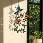 Hummingbird blooming vine holographic acrylic suncatcher hanging by a sunny wall and window with soft rainbow reflections