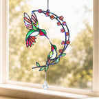 Hummingbird cherry blossom moon holographic acrylic suncatcher hanging on a bright window with soft natural light