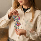 Person holding a hummingbird hibiscus holographic acrylic suncatcher to show product size