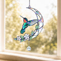 Hummingbird moon blossom holographic acrylic suncatcher hanging on a sunny window with soft natural light