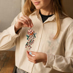 Woman holding hummingbird holographic acrylic suncatcher with branch and blossom design