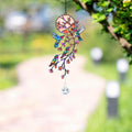 Hummingbird holographic acrylic suncatcher hanging outdoors with blooming branch design and crystal charm