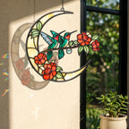 Close up of hummingbird crescent moon holographic acrylic suncatcher hanging on a bright window