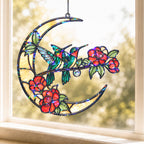 Hummingbird crescent moon holographic acrylic suncatcher hanging on a sunny window