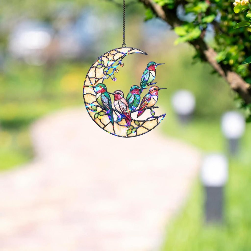 Moonlit hummingbird garden holographic acrylic suncatcher hanging by a sunny window with soft rainbow reflections