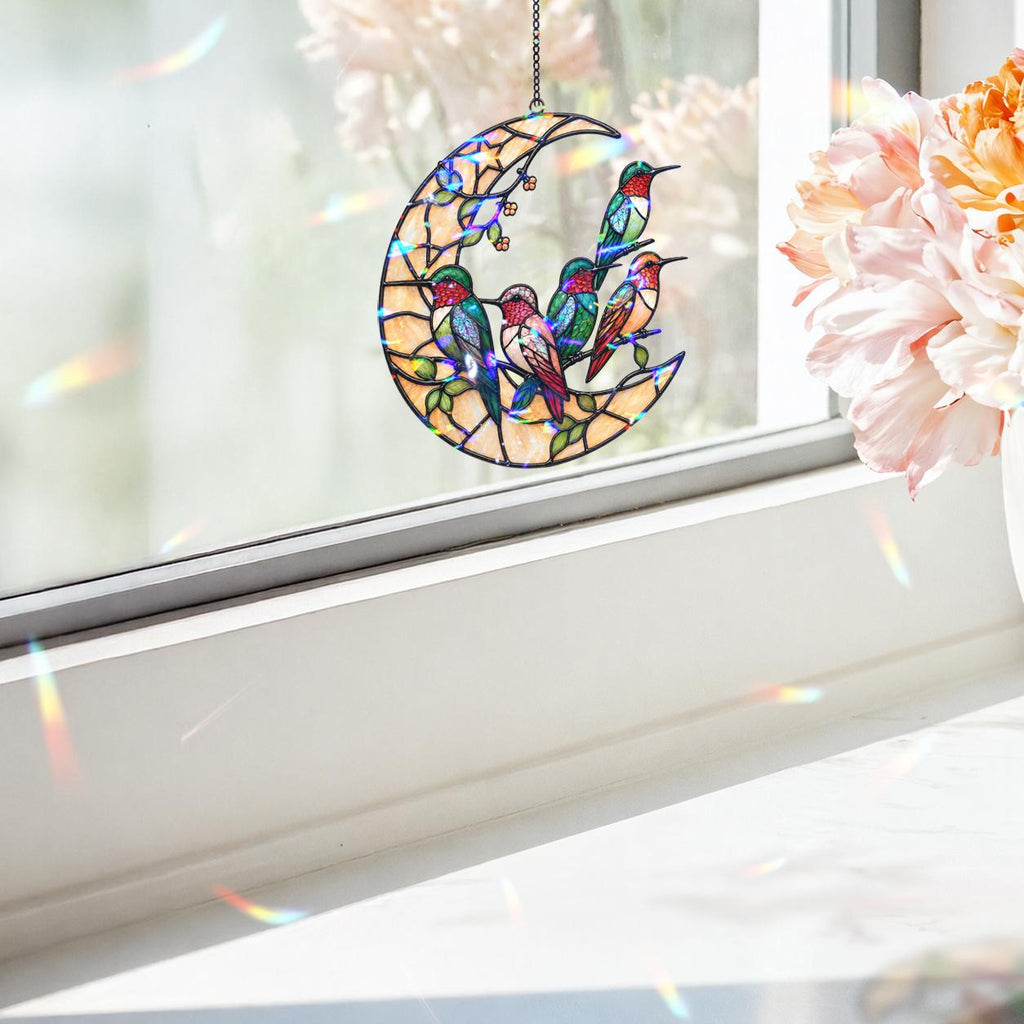 Moonlit hummingbird garden holographic acrylic suncatcher hanging outdoors with a soft green garden background